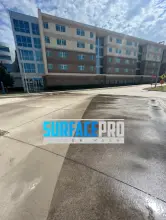 Cleaned concrete plaza at a multi-story commercial building in Richardson, TX