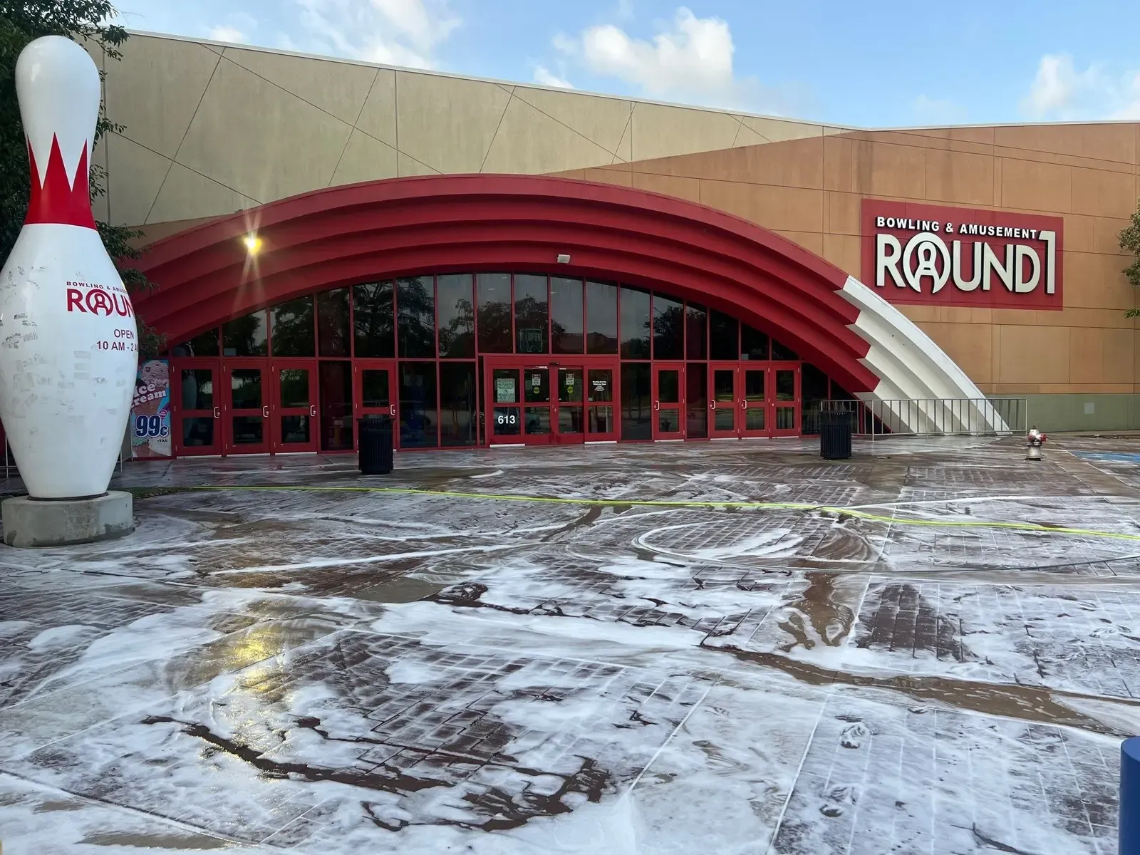 Cleaning solution dwelling on the entrance concrete of a bowling and amusement venue before rinsing