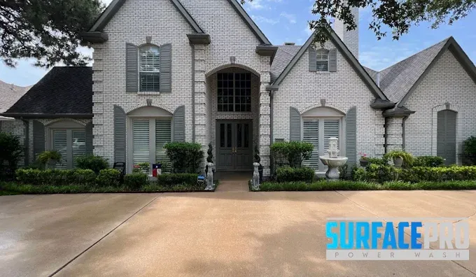 Soft washed painted brick home with a clean driveway in Richardson, TX