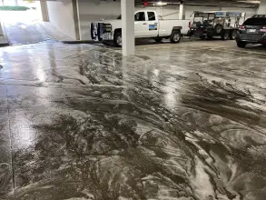 Pressure washing truck and trailer rig staged in a parking garage with detergent on the concrete in Richardson, TX